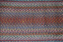 An approx. 6' x 2' oval blue Carnival runner