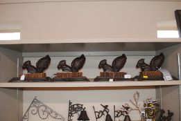 Four cast iron squirrel decorated boot scrapers