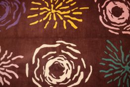 An approx. 8' x 5' brown rug having stylised flora