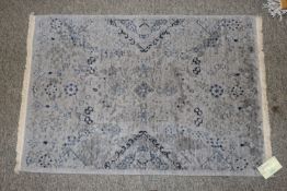 An approx. 3' x 2' Nirvana Peace grey rug