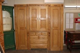 A large light oak finish breakfront wardrobe fitted