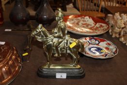 A 19th Century brass and cast iron doorstop in the