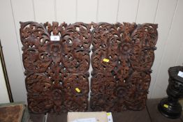 A pair of Indian carved wooden panels