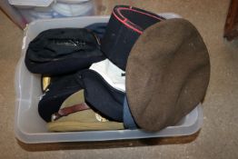 A crate full of various military hats and helmets
