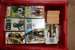 A box of vintage Western paperback books