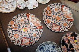 A pair of Imari scallop border plates