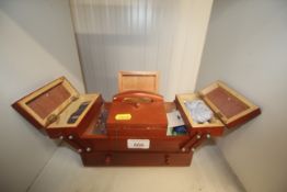 A small cantilever sewing box and contents