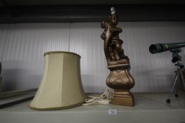 A cherub decorated table lamp and shade