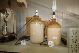 Two stoneware bottles converted to table lamps wit