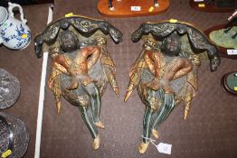 A pair of Golfar and Hughes decorative wall brackets