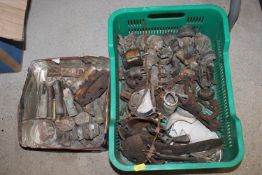A plastic crate and a tin of various WWII metal de