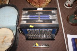 A Regal melodeon together with a German harmonica
