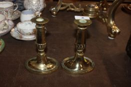 A pair of antique brass candlesticks