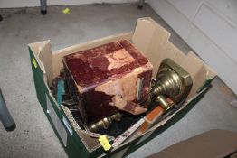 A box containing brass candlesticks; carriage cloc