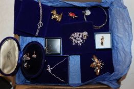 A box of costume jewellery to include a brooch in