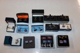 A box containing various pairs of cuff-links