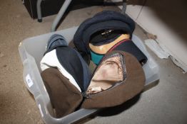 A box containing various military hats and helmets