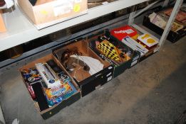 Four boxes containing miscellaneous games, dolls e