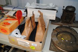 A pair of tan leather ladies boots; another pair a