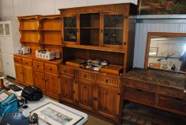 An oak dresser with glazed upper section and cupbo