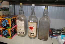 Three large vintage whisky bottles