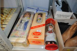 A collection of boxes and other dressed dolls