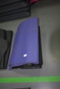 Four Black and One Purple Yoga Mats