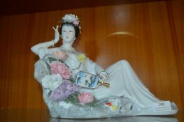 Pottery Figure of a Reclining Chinese Lady