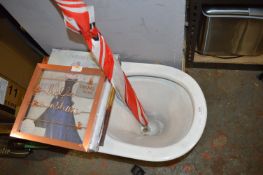 *Toilet, Umbrella, and a Quantity of Display Items