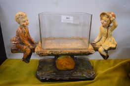 1930’s Fish Tank with Two Children on a Seesaw