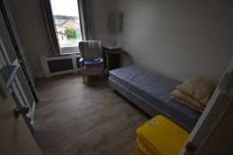 *Contents of Room 12 to Include Single Divan, Cantilever Bed Table, Wingback Armchair, and a