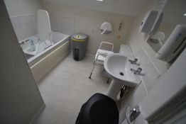 *Contents of Bathroom to Include Bath Chair, Wastebins, and a Toilet Riser