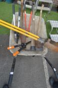 Wheelbarrow Containing Garden Tools, and a Posthole Scoop