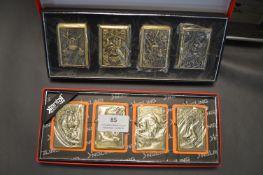 Two Sets of Four Earth Zippo Style Lighters