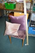 *Purple Upholstered Chair with Two Cushions and a Roll of Fabric
