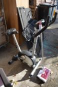 V-Fit Exercise Bike, and a Carpet Sweeper