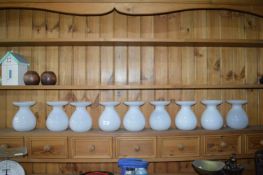 Nine White Glass Vases