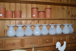 Nine White Glass Vases