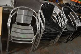 Eight Black Stackable Chairs and Two Chrome Effect Chairs