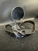 A wheel-mounted mirror on leather strap.