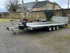 A Brian James triple axle tilt bed car transporter with winch attached