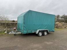 A twin axle car transporter with curtain sided covering