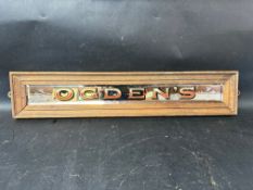 An Ogden's bevelled-edged etched mirrored advertising sign in wooden frame, 23 1/2 x 4 3/4