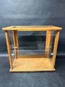 A glass tabletop display case with glass shelf, 18