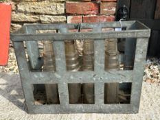 An Essolube 12 division crate containing eight Essolube glass oil bottles.