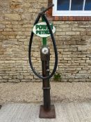 A skeleton pump with hose and nozzle, in good condition, older restoration.