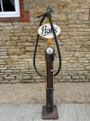 A skeleton pump with hose and nozzle, in good condition, older restoration.