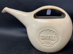 A Shell plastic watering can.