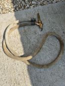 A good and early petrol pump canvas hose with brass nozzle.