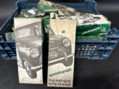 A tray of Speedograph fog and spot lamp brackets, new old stock.
